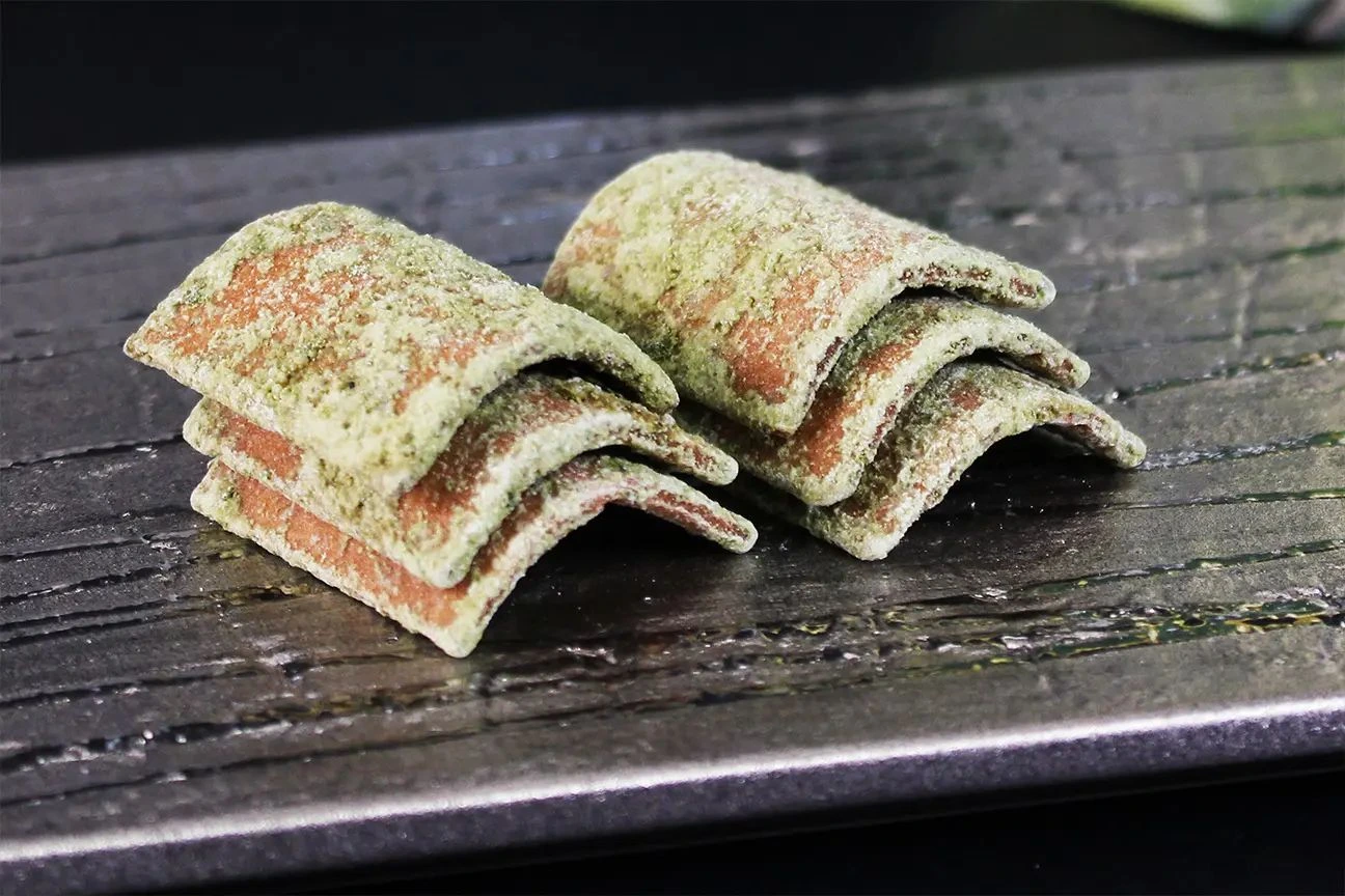 Authentic Uji Matcha Yatsuhashi confectionery on dark textured Japanese ceramic platter